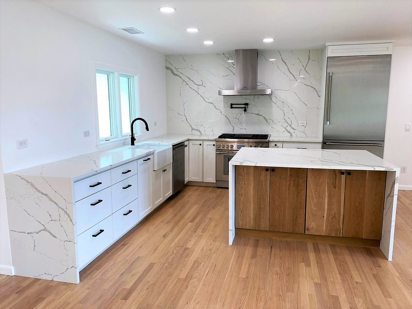 Marble waterfall island with walnut cabinetry