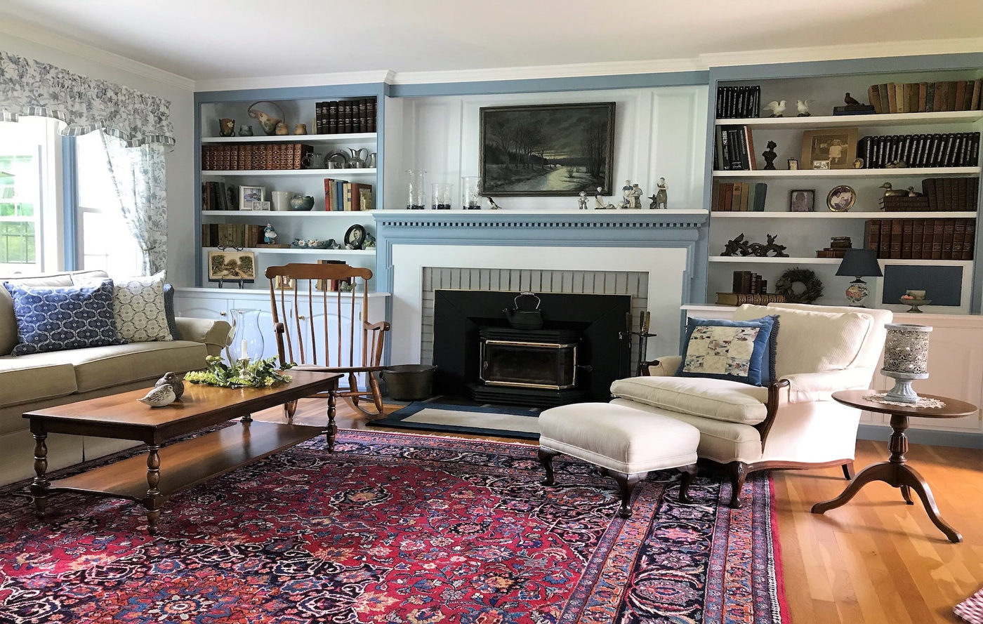 Living room with a wood-burning fireplace flanked by built-in bookshelves