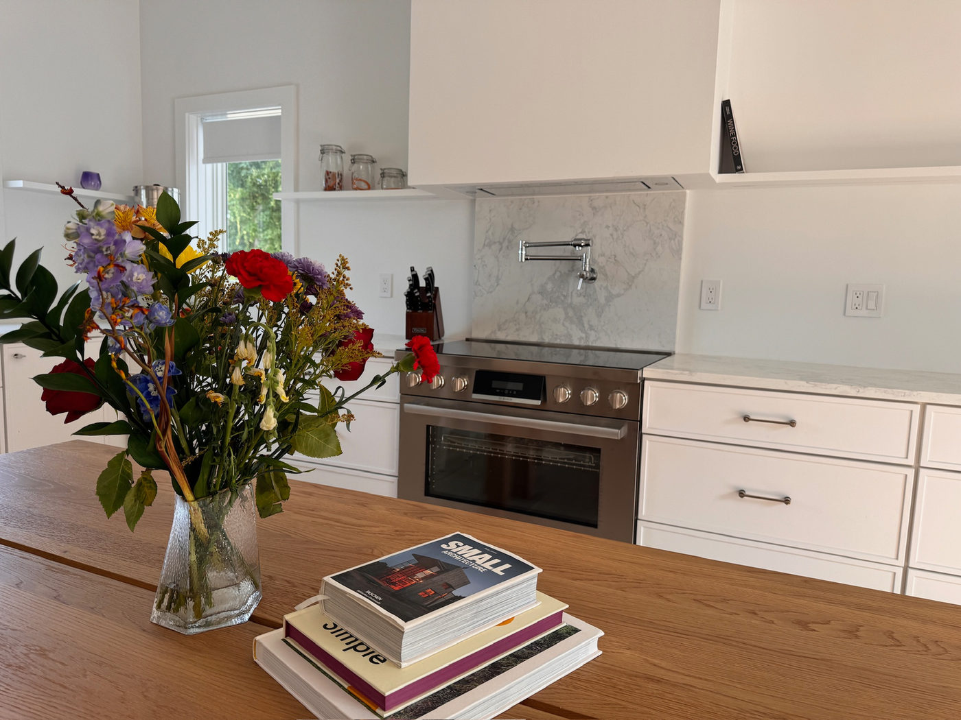 Kitchen with a marble backsplash, integrated range and a wood counter