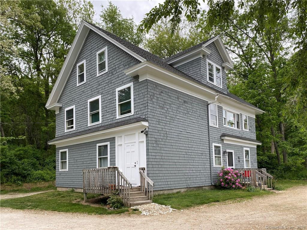 Grey-blue clapboard house with white trim and a covered side porch